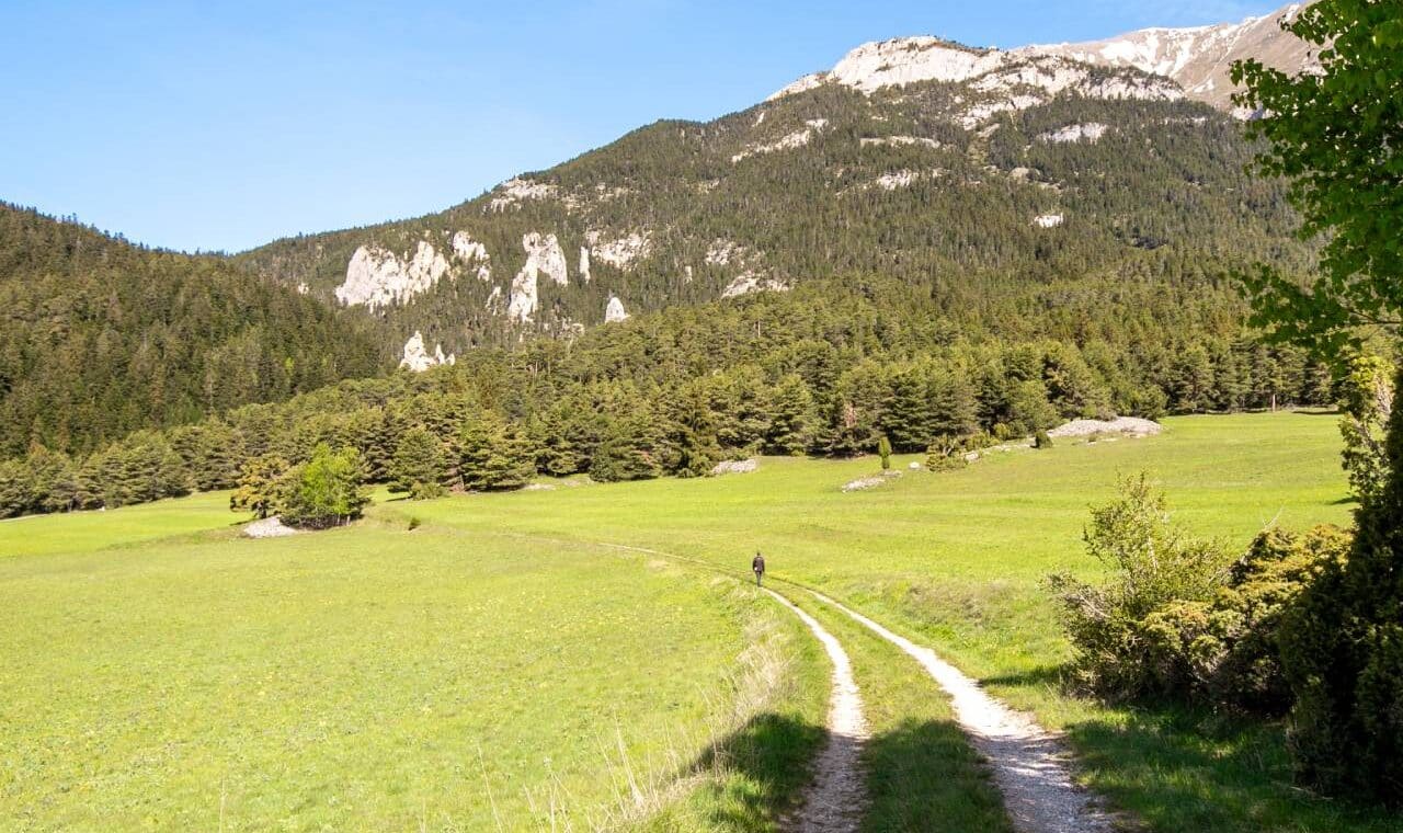 Hiker walking around the Sardières monolith