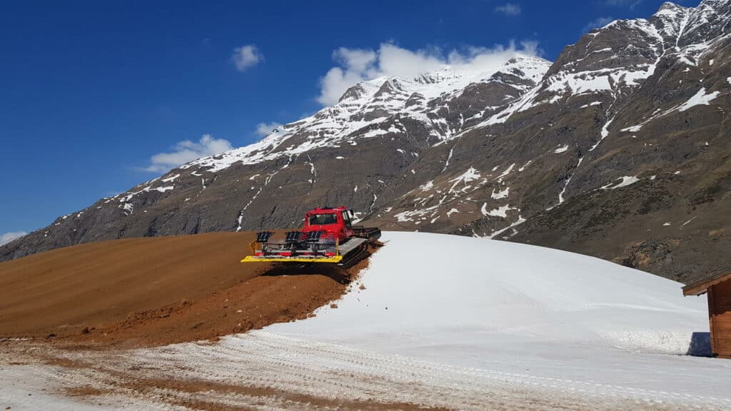 Snowfarming à Bessans, dameuse qui couvre la neige avec de la sciure pour la préserver du soleil et de la chaleur en été. La neige sera réutilisée l'hiver suivant.