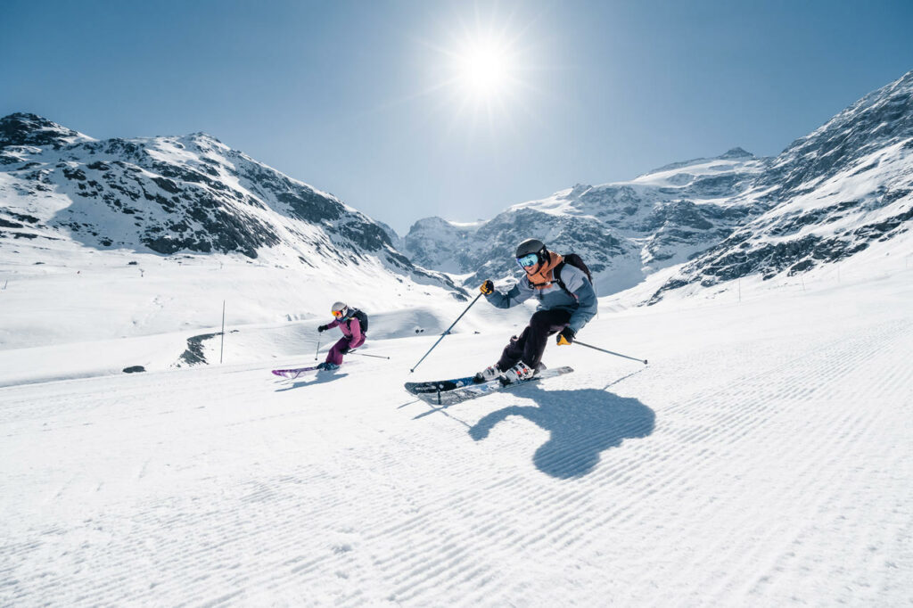 Alpine duo skiing on the slopes of Bonneval sur Arc in winter